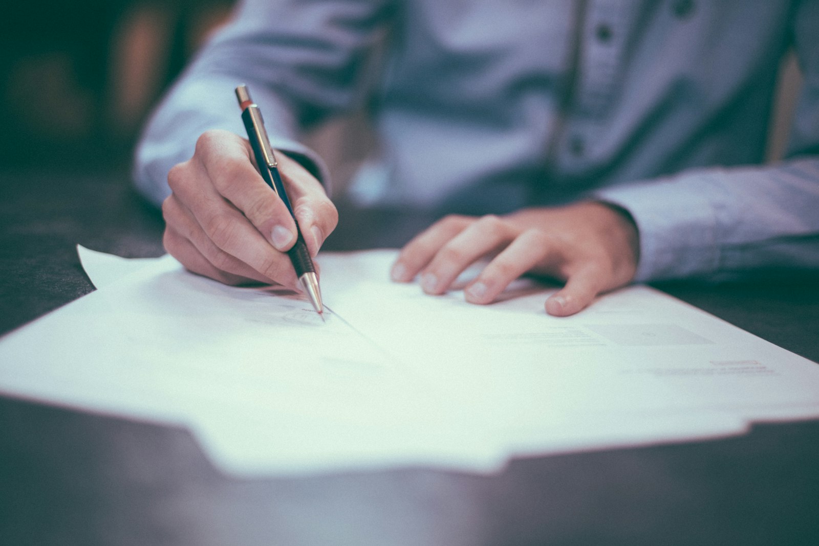 Couple signing estate documents together