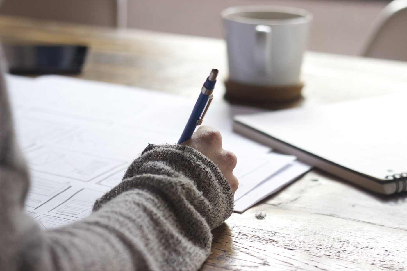 Person planning documents at a desk